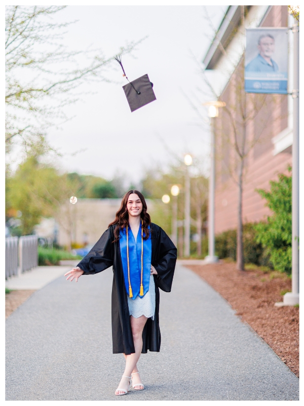 College graduate throwing mortar board in the air