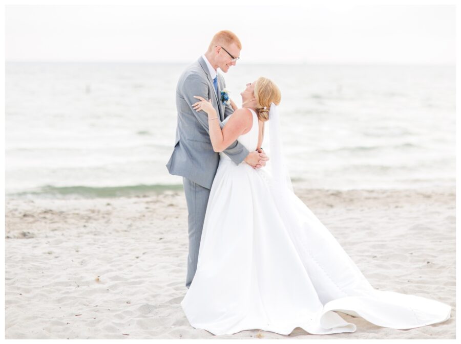 Bride and groom hugging on the beach