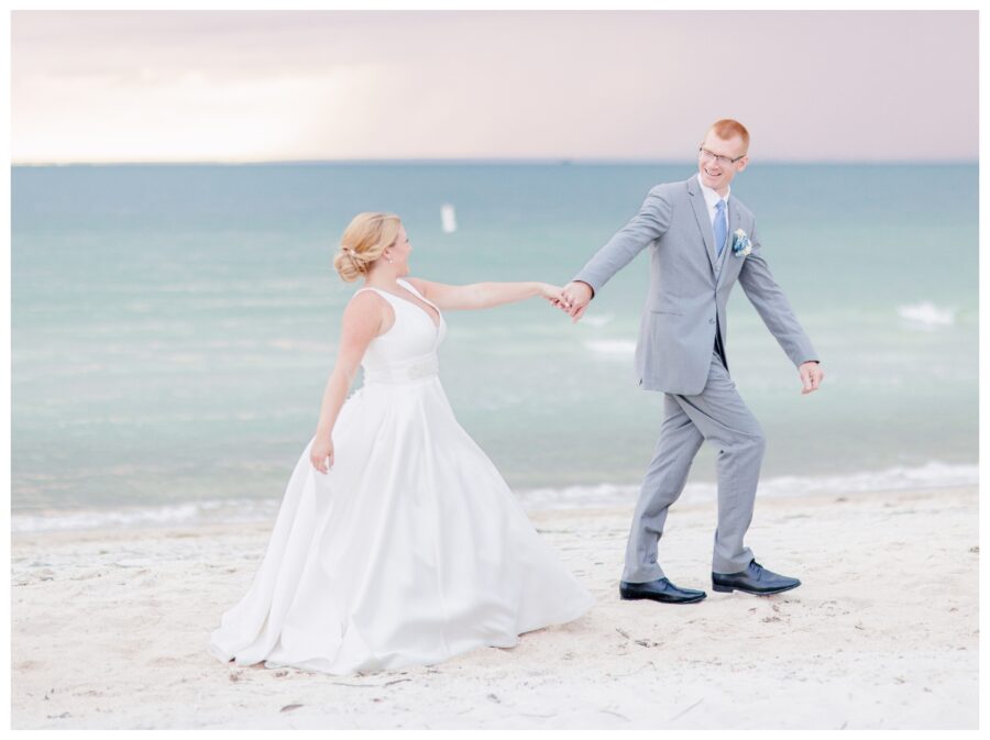 Bride and groom walking down the beach