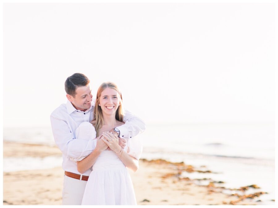Couple hugging on the beach Dennis Engagement Session Cape Cod