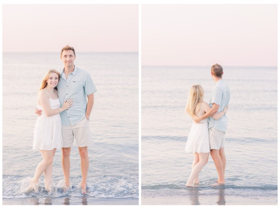 Couple standing in the ocean and looking at the sunset at Wingaersheek Beach Engagement session in Gloucester, MA