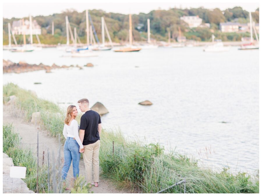 A couple holding hands walking down the path at The Knob Engagement Session Falmouth, MA Cape Cod