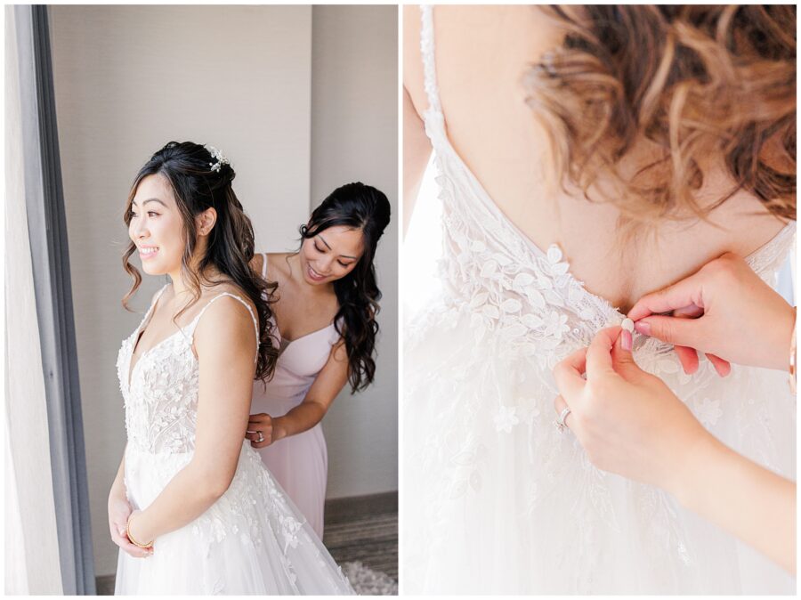 Bride getting buttoned into her wedding dress by bridesmaid