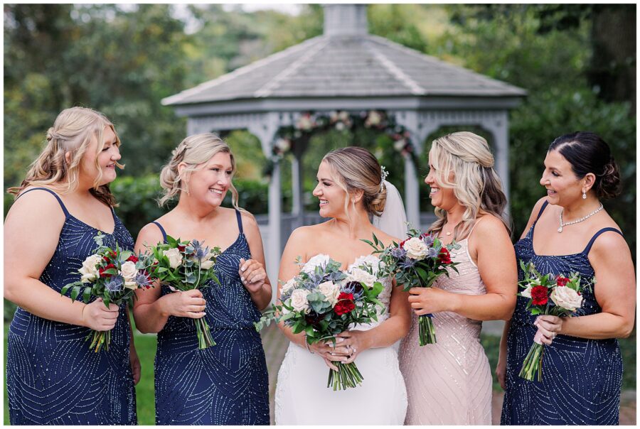 Bride and bridesmaids looking at each other and laughing