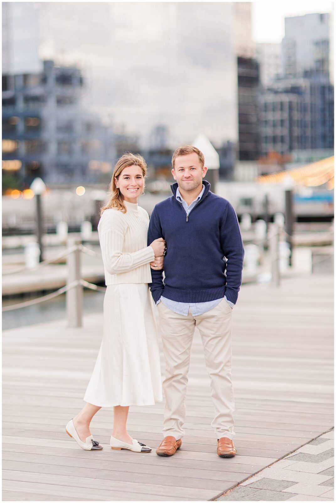 Woman hugging her fiancé during Boston Seaport engagement session.
