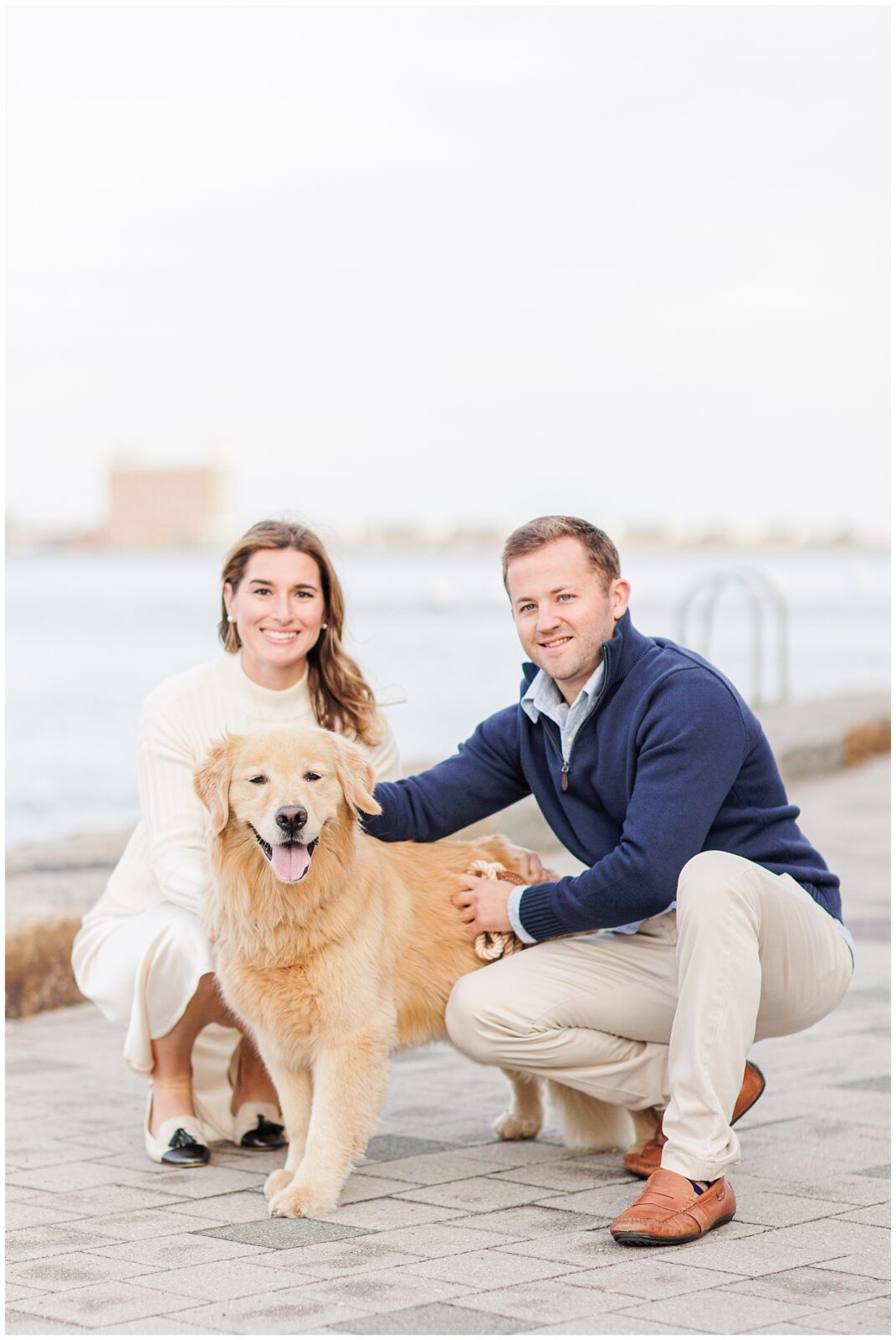 Couple sitting with their golden retriever dog during engagement session.