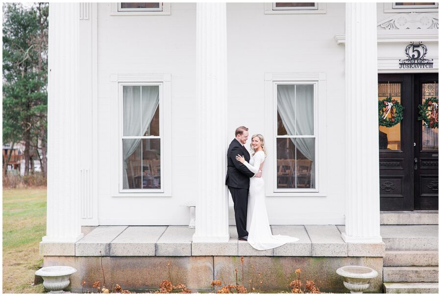 Bride and groom hugging outside of a historical home during their central MA elopement.