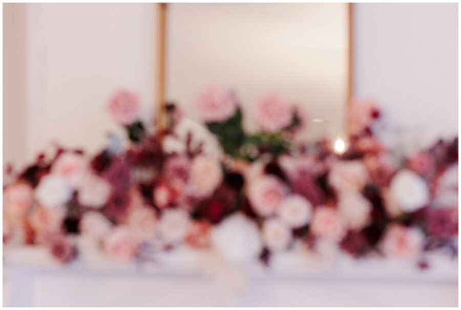Intentionally blurry picture of wedding florals for ceremony