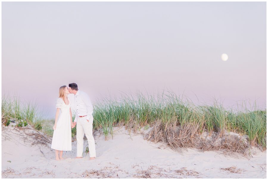 Bride and groom kissing on the beach with the moon in the background Chapin Beach Dennis, MA Cape Cod