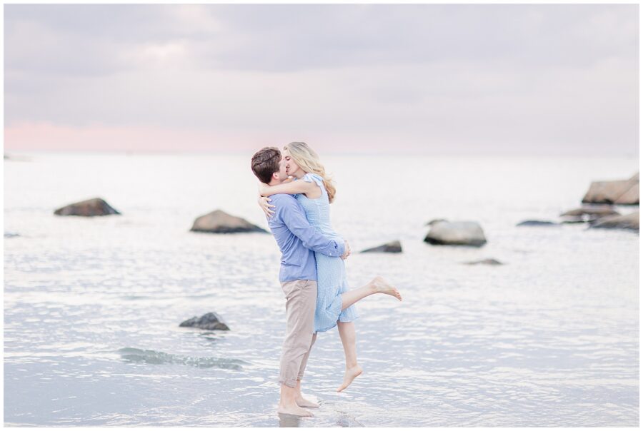 Man hugging and kissing a woman at the beach