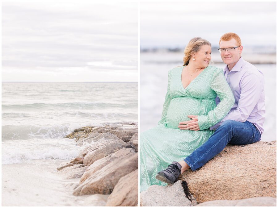 Waves crashing against rocks at Old Silver Beach in Falmouth, MA Cape Cod while couple sits on the rocks and hold on to baby bump