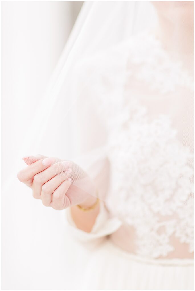 Close up of hand holding a wedding veil