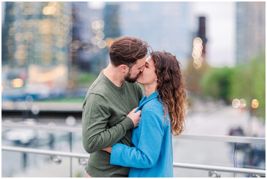 Couple kissing during their engagement photos in Boston's Seaport district