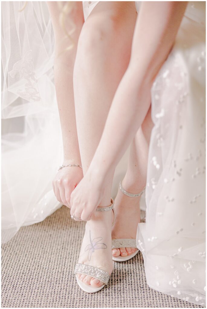 Close up of a bride putting on her shoes before her New Hampshire wedding