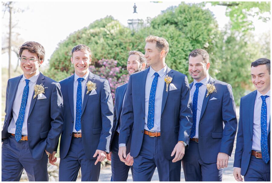 Groom and groomsmen smiling and laughing