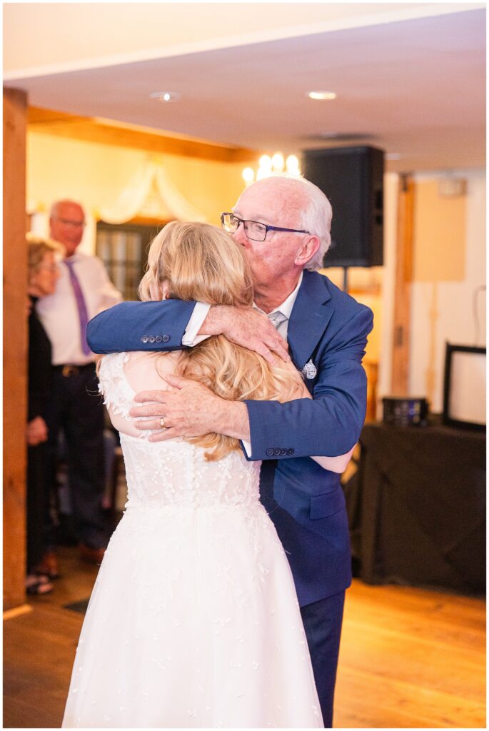 Father kissing bride during their first dance during a New Hampshire wedding
