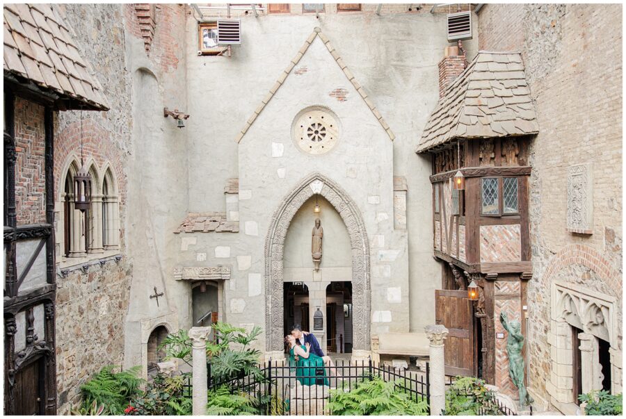 Couple sharing a kiss inside of Hammond Castle during their engagement session