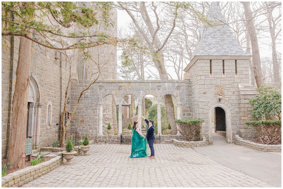 Couple twirling at main entrance to Hammond Castle