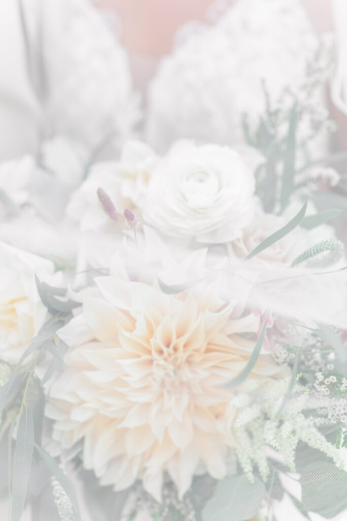 A bridal bouquet with a wedding veil over the flowers representing a Cape Cod wedding photographer portfolio