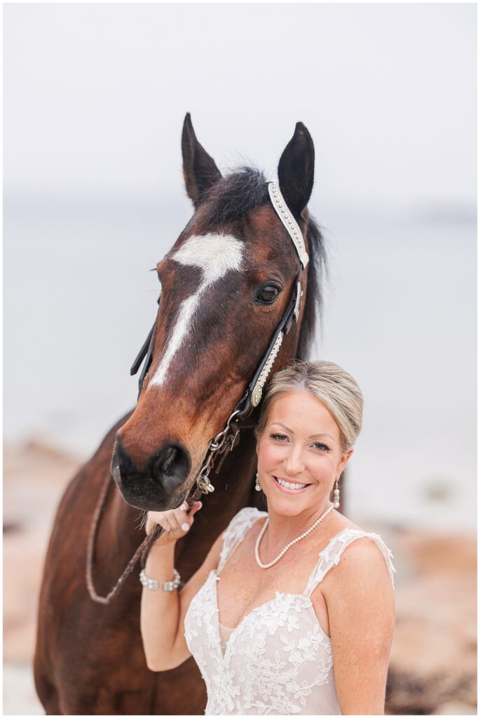 Bride holding her horse's reigns and smiling 