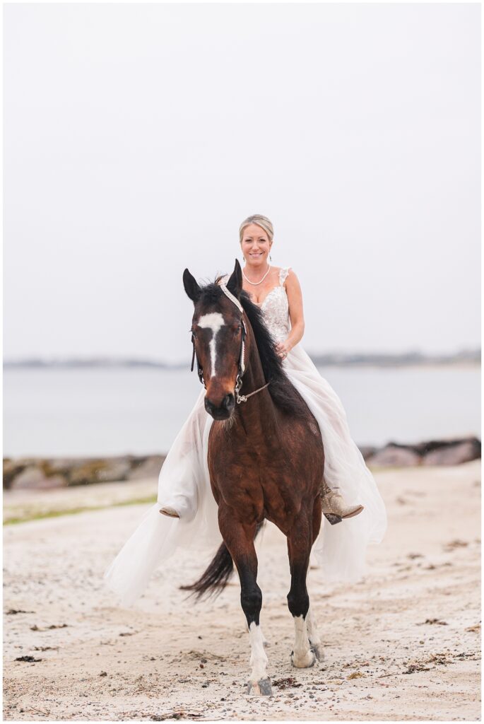 Bride trotting with her horse during her Cape Cod bridal picture session