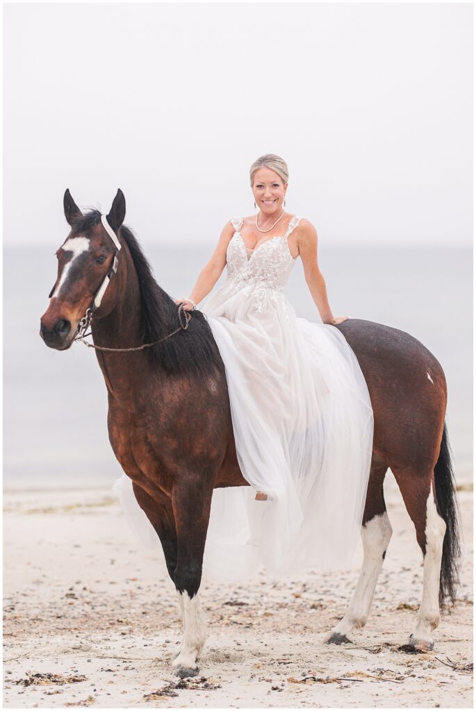 Bride sitting on her horse and leaning back to smile at the camera