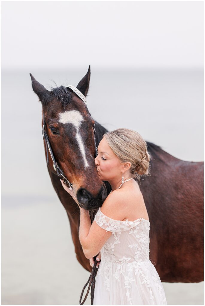 Bride kissing her horse during her Cape Cod bridal photos