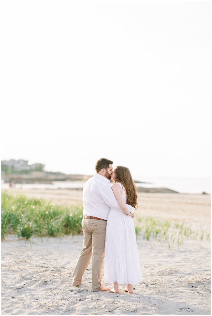 A man hugging and kissing a woman at Wingaersheek