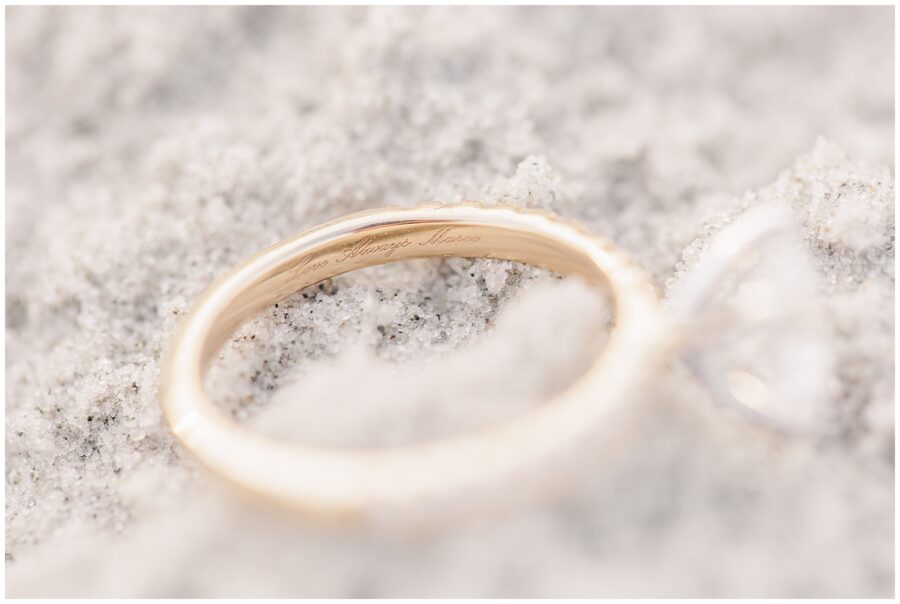 Close up of an engraving reading, "Love Always Marco" on an engagement ring