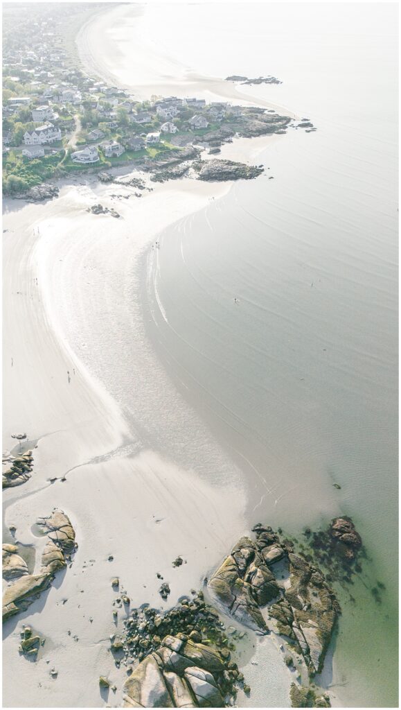 Aerial shot of Wingaersheek Beach showing sand, the ocean, and coastal homes