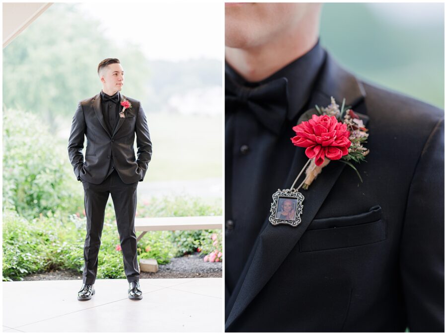 Groom in a black tuxedo with a red boutonniere.