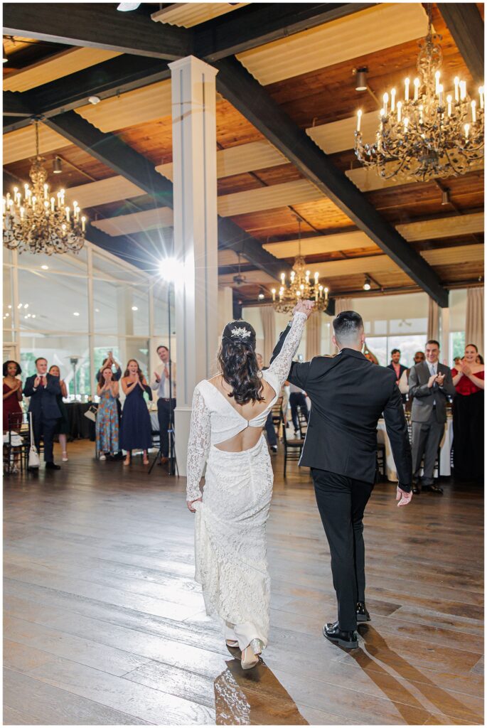 Bride and groom entering the reception at the Cape Club of Sharon.