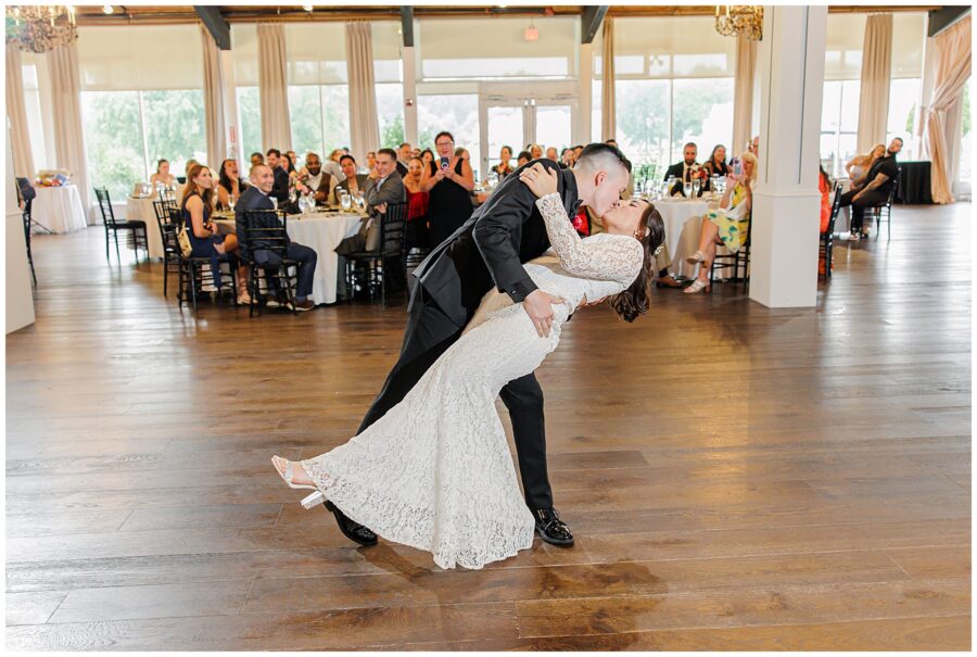 Groom dipping and kissing the bride on the dance floor.