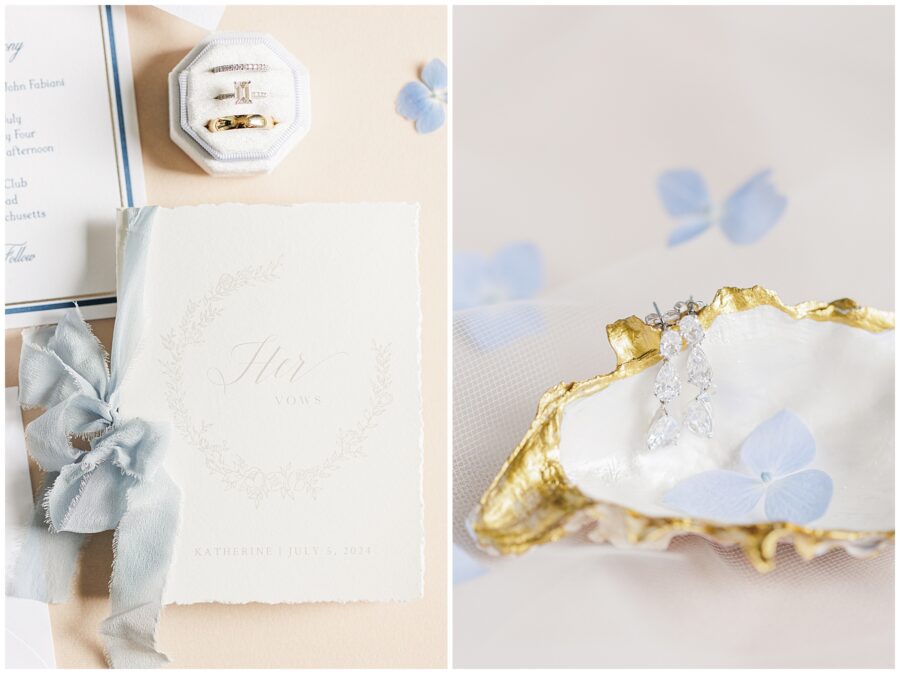 Vow book and earrings on a gold-trimmed dish.