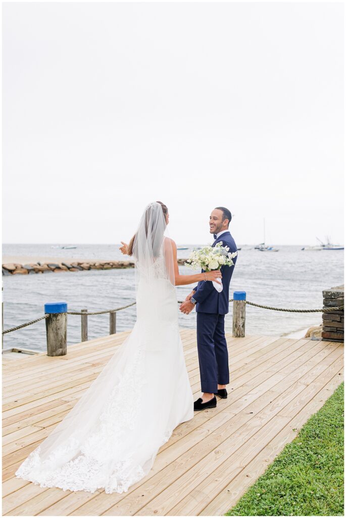 Bride and groom first look by the water at Wychmere Beach Club.