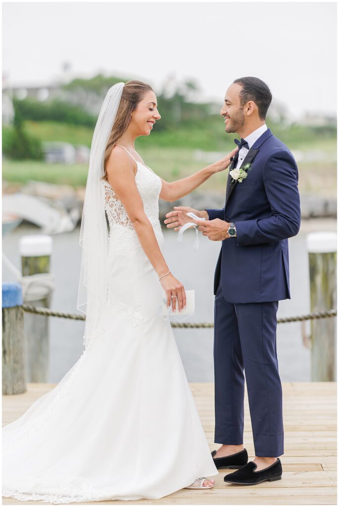 Bride and groom smiling after reading vows at Wychmere Beach Club.