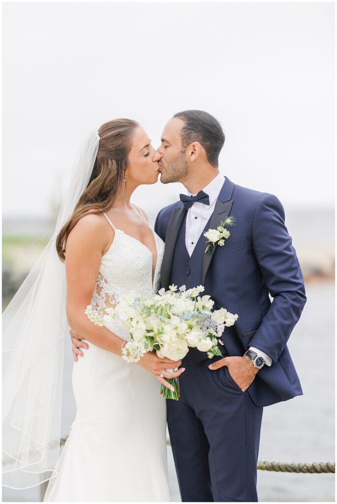 Bride and groom kissing at Wychmere Beach Club.