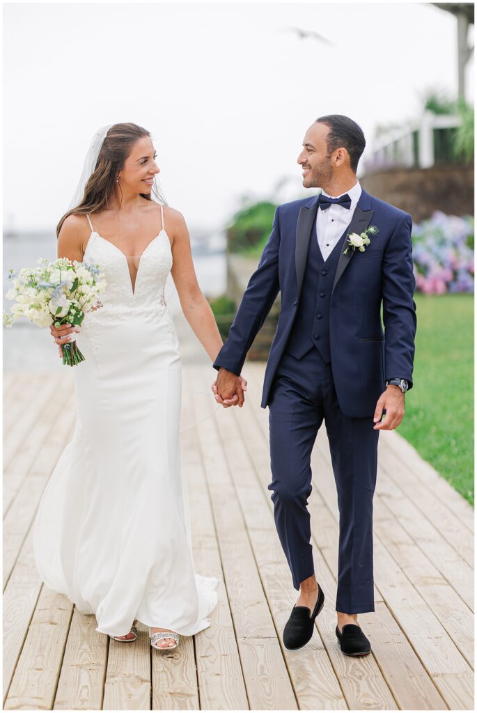 Bride and groom walking hand-in-hand after wedding.