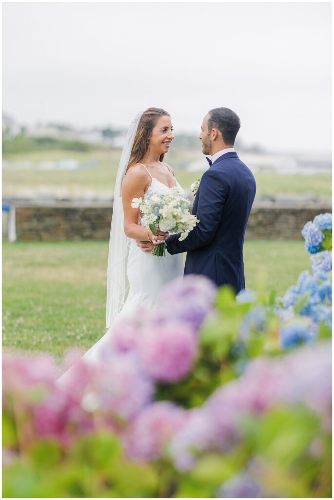 Bride and groom at the Wychmere Beach Club wedding, standing in a garden with hydrangeas.