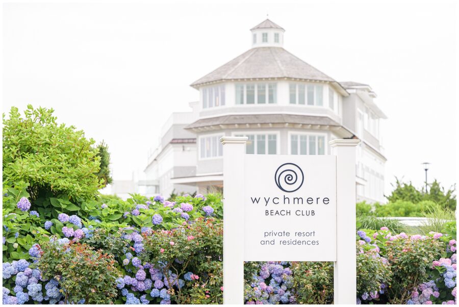 Wychmere Beach Club sign with building and hydrangeas in the background.