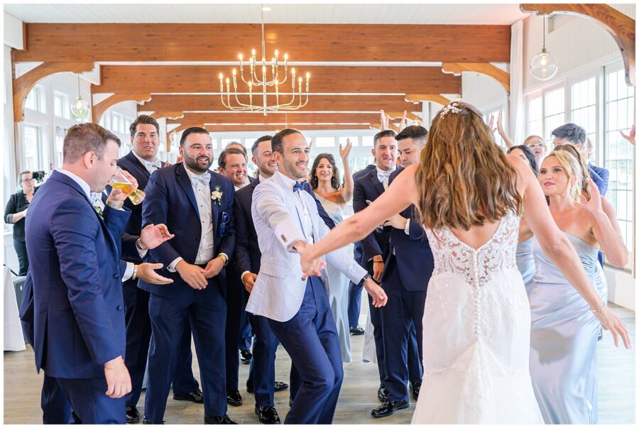 Bride and groom dancing with their wedding party during their Cape cod wedding