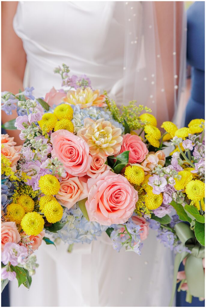 Close-up of the bride’s bouquet at Pembroke Pines Country Club, featuring pink roses, yellow chrysanthemums, and soft blue hydrangeas.