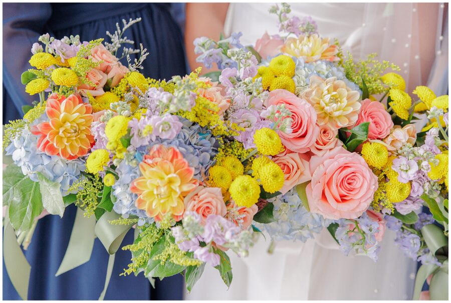 Colorful wedding bouquets held by the bride and bridesmaids at Pembroke Pines Country Club, featuring a mix of roses, chrysanthemums, and hydrangeas.