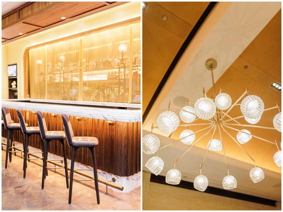 A wide shot of the Avery Bar featuring a marble countertop, dark wood paneling, and plush barstools. The golden glow from the backlit liquor display creates an elegant ambiance. The second image in the set is a close-up of a chandelier with intricate glass light fixtures.