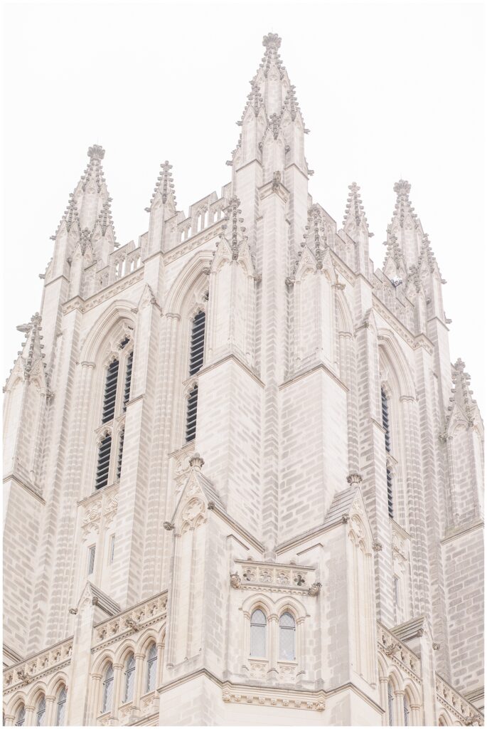 A view of the Washington National Cathedral’s ornate stone tower featuring pointed spires, gothic arches, and intricate carvings.