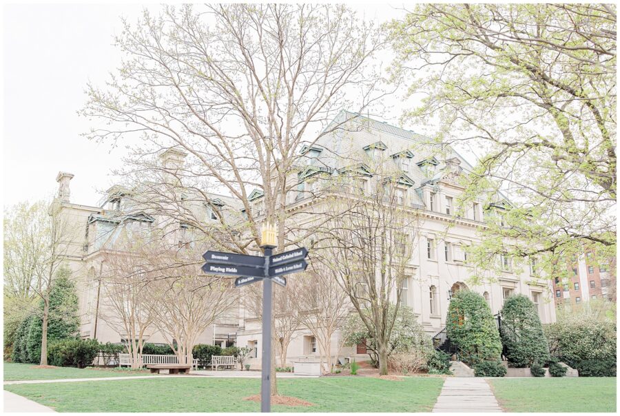 Exterior view of Hearst Hall at the National Cathedral School, showing its classic architecture with detailed stonework, tall windows, and a slate roof partially framed by trees.