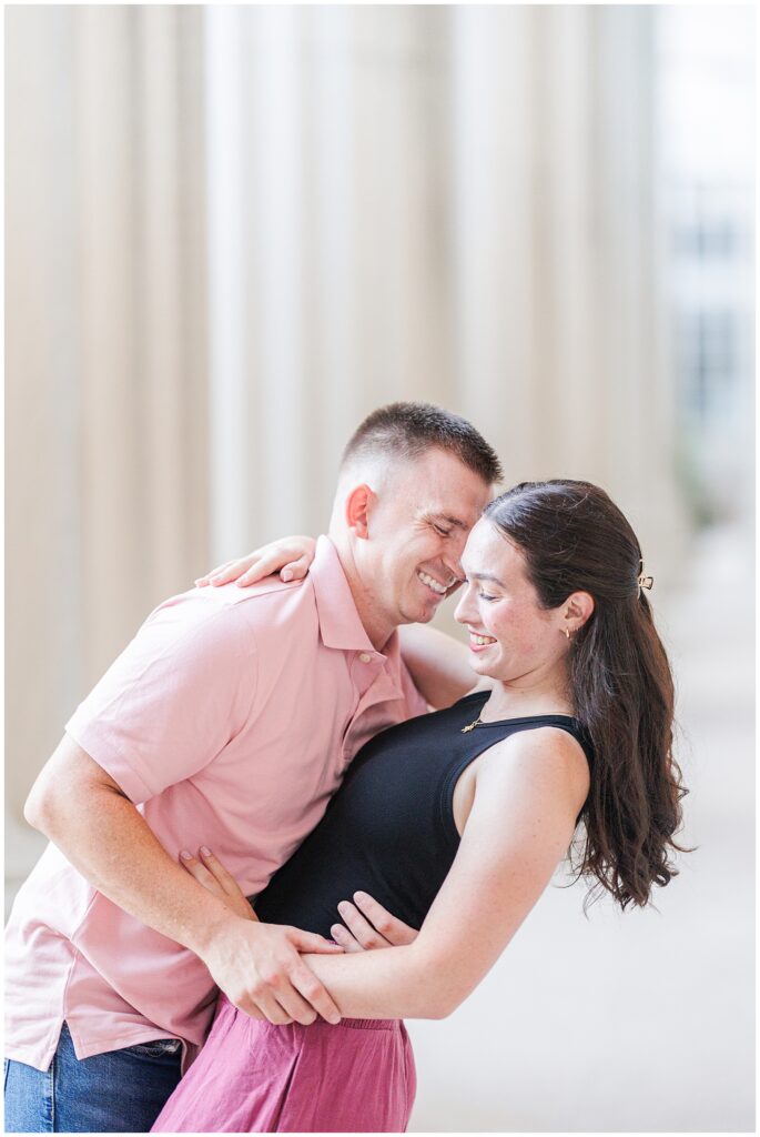 Close-up of a couple laughing together, foreheads touching affectionately. Taken at MIT by a Cambridge photographer.