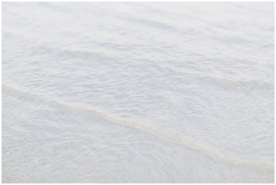 Close-up of clear ocean water rippling at the shoreline of Wingaersheek Beach.