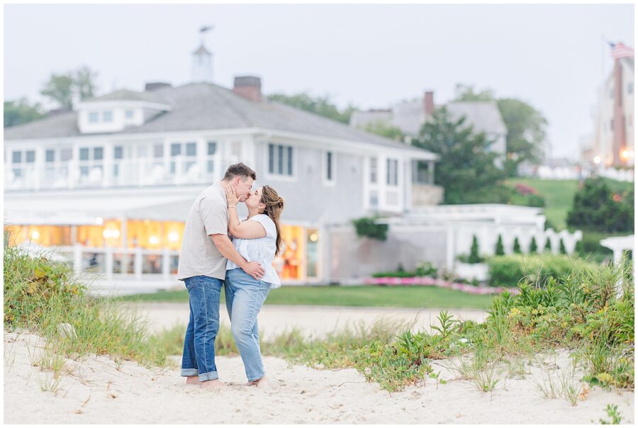 Couple kissing in front of the historic Chatham Bars Inn building during engagement session