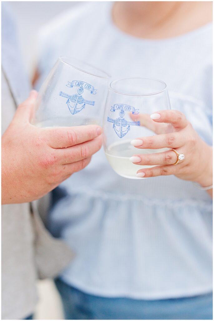 Close-up of couple holding Cape Cod wine glasses during Chatham Bars Inn engagement celebration